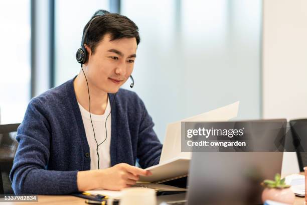 confident asian businesswomen talking to the camera video calling video conference with his business partners in office. - camera operator stock pictures, royalty-free photos & images