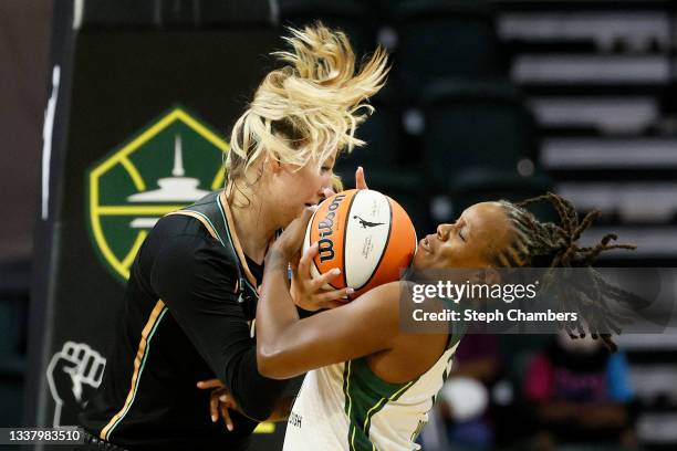 Kylee Shook of the New York Liberty and Epiphanny Prince of the Seattle Storm fight for the ball during the second quarter at Angel of the Winds...