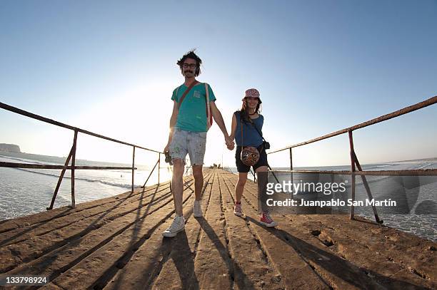 couple on dock of arica - arica fotografías e imágenes de stock