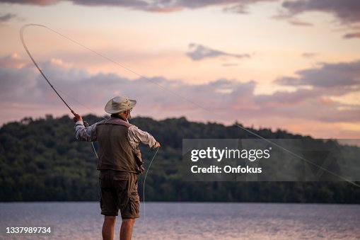 Senior Man Fly-Fishing at Sunset Senior Man Fly-Fishing at Sunset