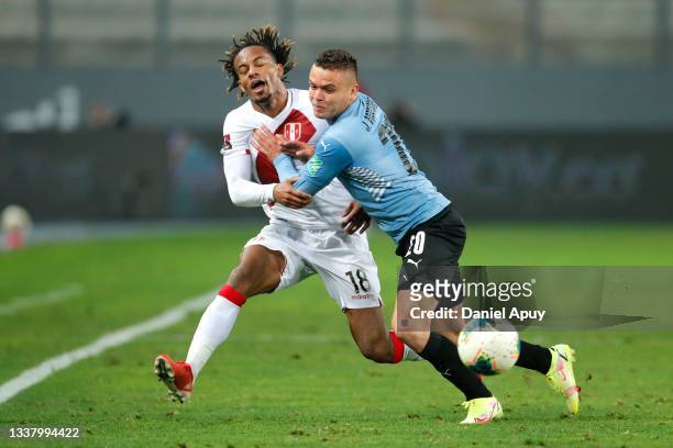 André Carrillo of Peru fights for the ball with Jonathan Rodriguez of Uruguay during a match between Peru and Uruguay as part of South American...