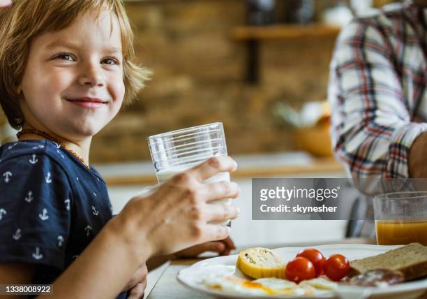 cute happy boy enjoying in breakfast in dining room. - mother son milk imagens e fotografias de stock