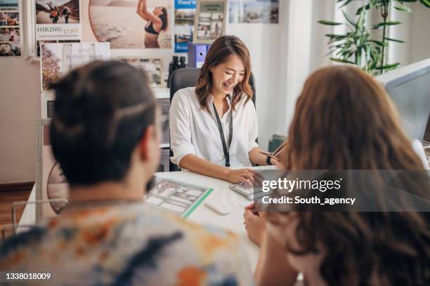 young couple going on vacation - travel agent stock pictures, royalty-free photos & images