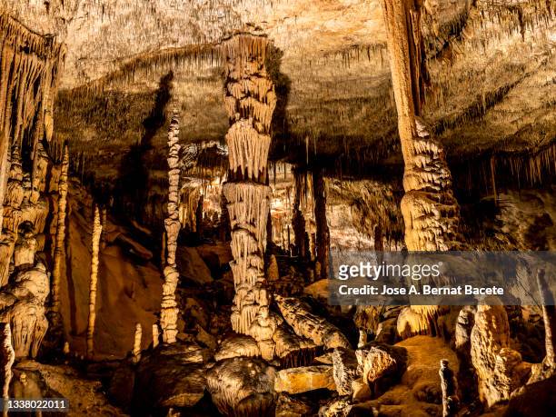 interior of a cave with large stalactites and stalagmites. - stalagmite stock pictures, royalty-free photos & images