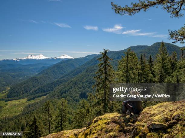 hiker taking in the view of the cascade peaks from castle rock trail, willamette national forest, oregon. - willamette national forest stock pictures, royalty-free photos & images