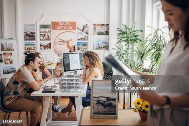 busy day in travel agency - travel agency stock pictures, royalty-free photos & images