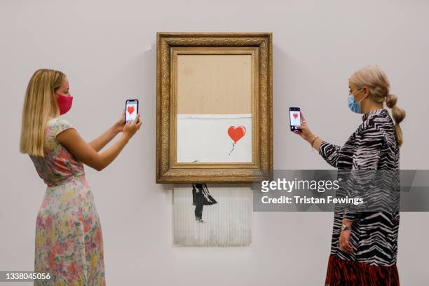 Banksy's Love is in the Bin is installed at Sotheby's on September 03, 2021 in London, England. Banksy's Love is in the Bin will go on public view...