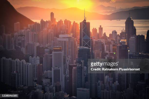hong kong cityscape skyline at sunset from the famous tourist place jardine's lookout in hong kong - tsim sha tsui stock pictures, royalty-free photos & images