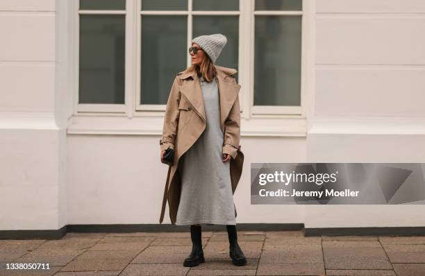 Elise Soho wearing Hey Soho grey midi dress, black Copenhagen Studios boots and Stella McCartney beige trenchcoat on August 30, 2021 in Hamburg,...