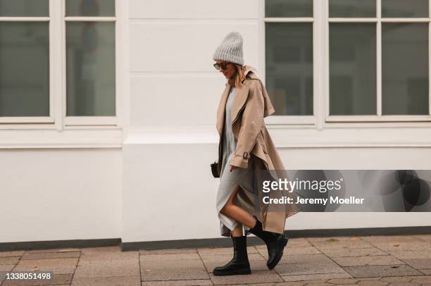 Elise Soho wearing Hey Soho grey midi dress, black Copenhagen Studios boots and Stella McCartney beige trenchcoat on August 30, 2021 in Hamburg,...