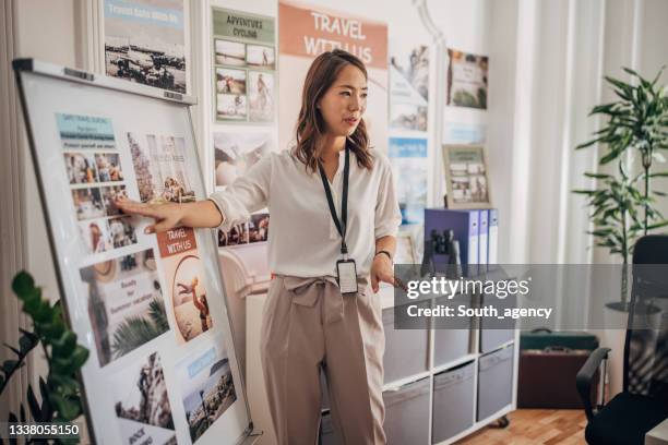 woman working in travel agency - agency stock pictures, royalty-free photos & images