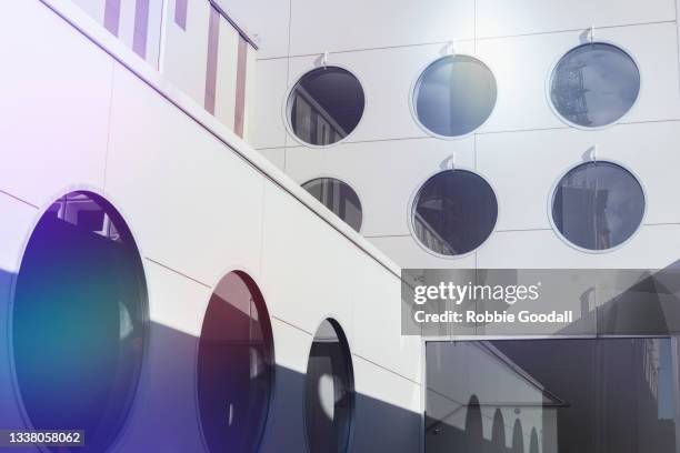 low angle view of a city building with dark round windows - perth property stock pictures, royalty-free photos & images
