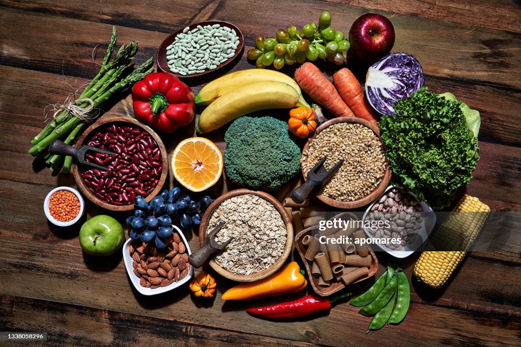 Top view of dietary fiber fresh vegan food and legumes on rustic wooden table. Healthy food themes with frame and copy space.