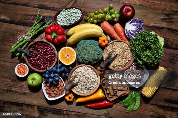 top view of dietary fiber fresh vegan food and legumes on rustic wooden table. healthy food themes with frame and copy space. - fiber imagens e fotografias de stock