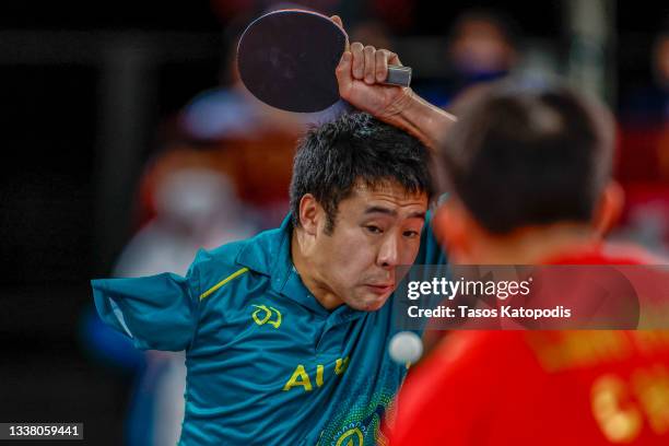 Lin Ma of Team Australia competes with Lian Hao of Team Peoples Republic of China in the men's table tennis team classes 9-10 gold match on day 10 of...