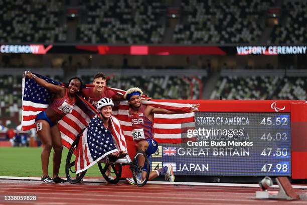 Brittni Mason, Nick Mayhugh, Tatyana McFadden and Noah Malone of Team United States celebrate after winning gold in the 4x100m Universal Relay on day...