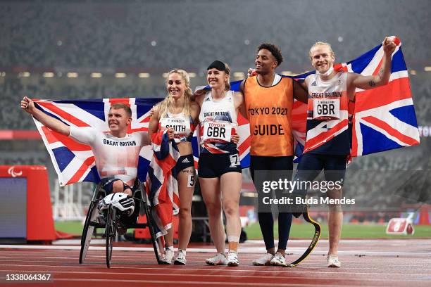 Nathan McGuire, Ali Smith, Libby Clegg, guide Chris Clarke and Jonnie Peacock of Team Great Britain celebrate after winning silver in the 4x100m...