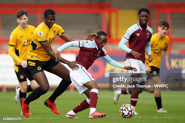 Amadou Diallo of West Ham United is challenged by Yerson Mosquera of Wolverhampton Wanderers during the Premier League Cup match between...