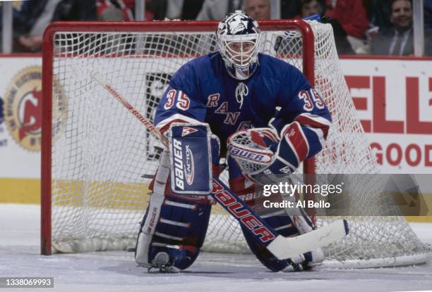 Mike Richter, Goaltender for the New York Rangers looks on from behind his mask tending goal during the NHL Eastern Conference Atlantic Division game...