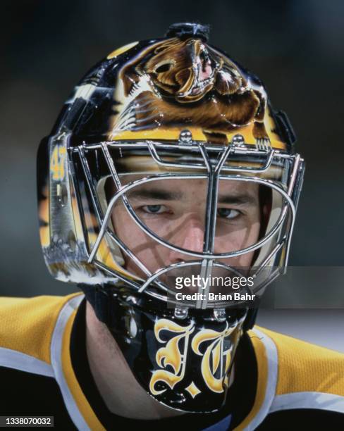 John Grahame, Goaltender for the Boston Bruins looks on from behind his mask while tending goal during the NHL Western Conference Northwest Division...