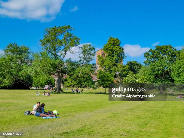 st albans cathedral and people enjoying the summer sunshine - hertfordshire stock pictures, royalty-free photos & images