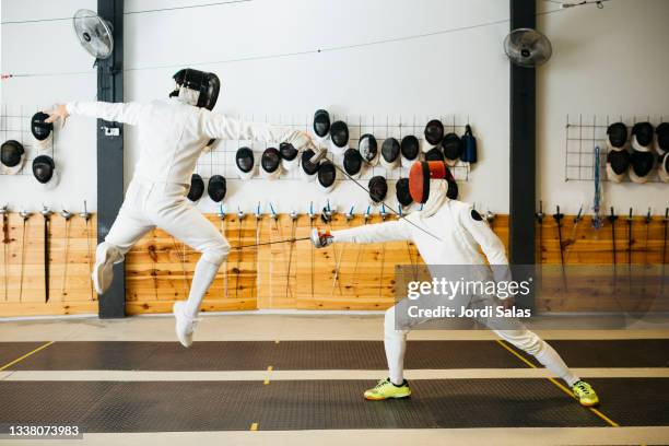 fencers training in gym - foil foto e immagini stock
