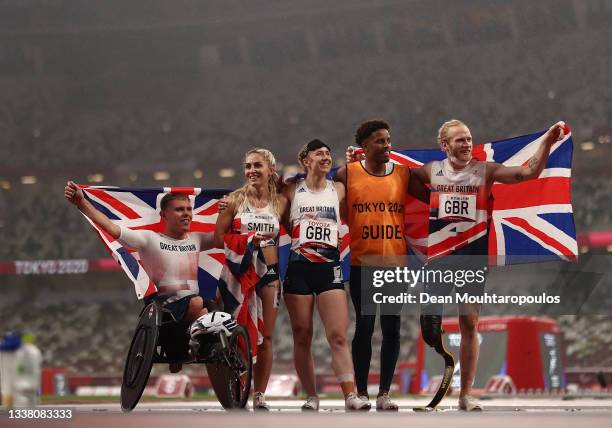 Nathan McGuire, Ali Smith, Libby Clegg, guide Chris Clarke and Jonnie Peacock of Team Great Britain celebrate after winning silver in the 4x100m...