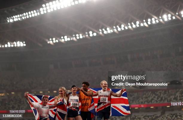 Nathan McGuire, Ali Smith, Libby Clegg, guide Chris Clarke and Jonnie Peacock of Team Great Britain celebrate after winning silver in the 4x100m...