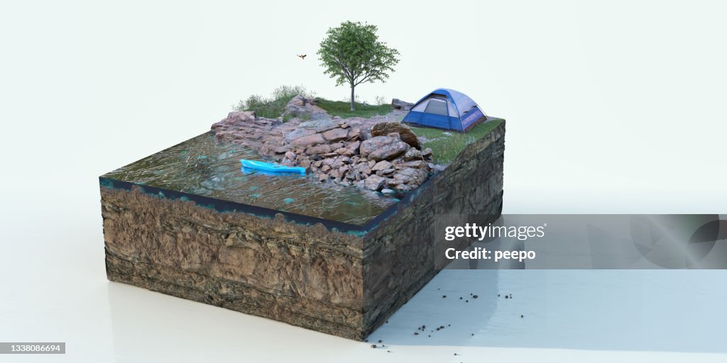 A Square Cross Section Of Ground With Lake, Rocks, Grass, Flowers and Tree Beside a Pitched Camping Tent