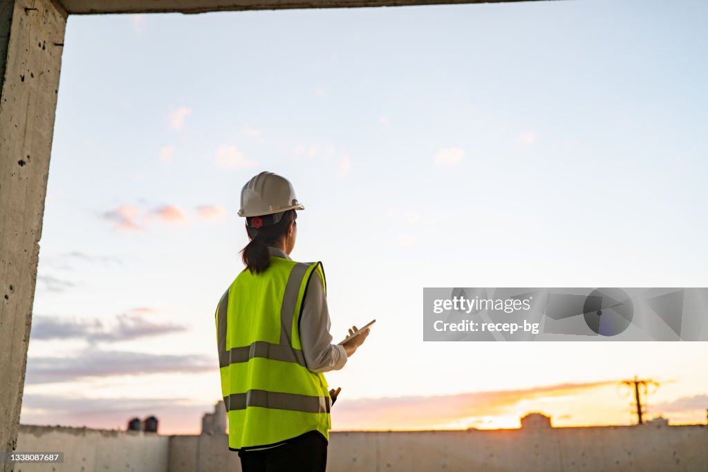 Young female engineer using digital tablet on construction site