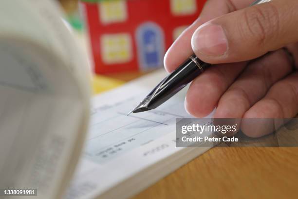 Signing Cheque Photos and Premium High Res Pictures - Getty Images