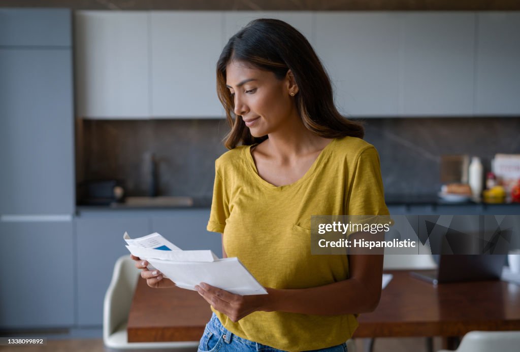 Woman at home checking the mail