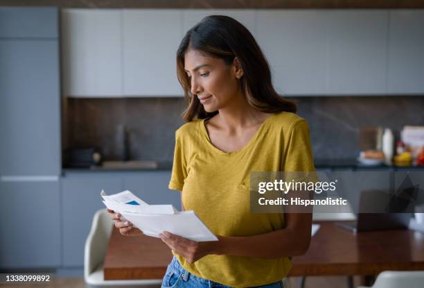 woman at home checking the mail - utility bill envelope stock pictures, royalty-free photos & images