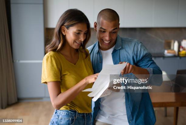 excited couple getting good news in the mail - college admissions letter stock pictures, royalty-free photos & images