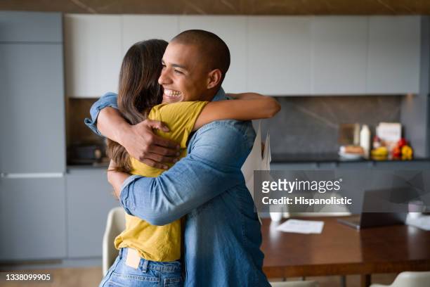 happy couple celebrating getting good news in the mail - good news stock pictures, royalty-free photos & images