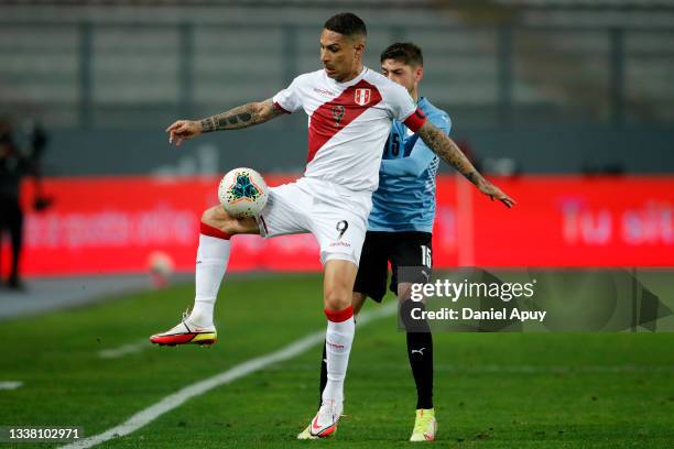 Paolo Guerrero of Peru fights for the ball with Federico Valverde of Uruguay during a match between Peru and Uruguay as part of South American...