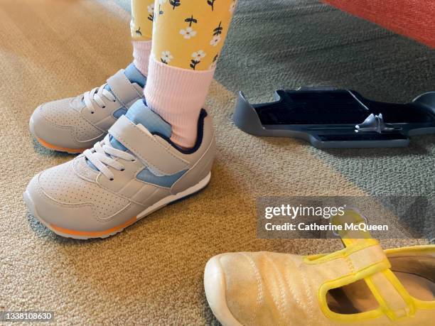 young girl tries on new sneakers for school in store - emotionella pubertetsbesvär bildbanksfoton och bilder