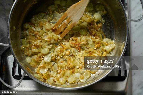 golden sauteed onions in the pan - lök bildbanksfoton och bilder