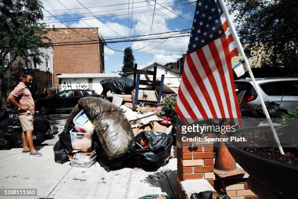 Person sorts through belongings from their flooded home in a Queens neighborhood that saw massive flooding and numerous deaths following a night of...