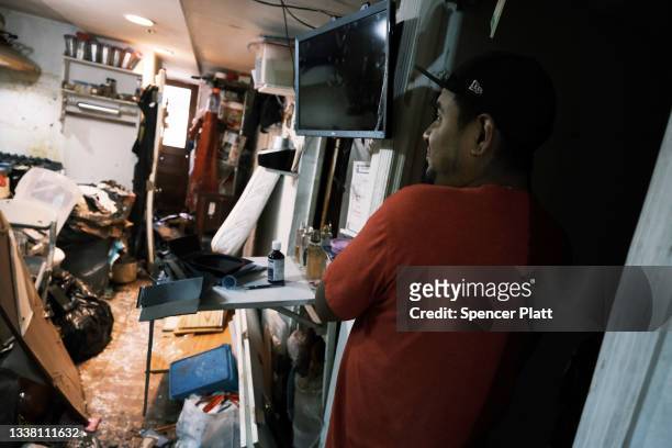 Eddie, an immigrant from Mexico, walks through his flooded basement level apartment in a Queens neighborhood that saw massive flooding and numerous...