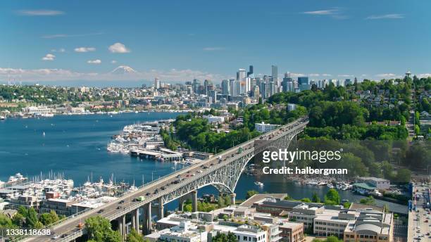 drone shot of seattle with mt rainier in distance - seattle stock pictures, royalty-free photos & images