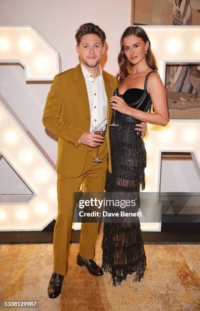 Niall Horan and Mia Woolley attend the Horan & Rose Show: Modest! Golf co-founder Niall Horan and Justin Rose brought the world of music and sport...