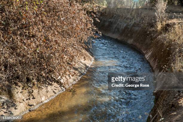 An irrigation canal, part of 170-mile water network operated by the Placer County Water Authority, is viewed looping along the hillside topography on...