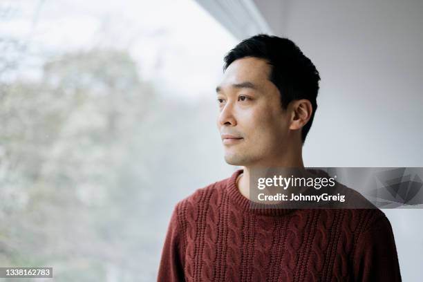 close-up of relaxed early 40s chinese man looking at view - pensive bildbanksfoton och bilder