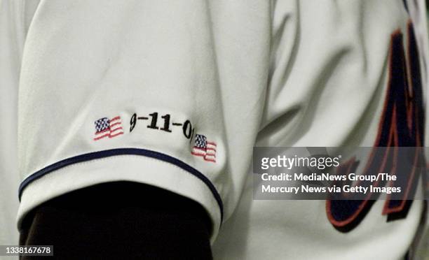 Players of the New York Mets wore special uniforms embroidered with 9-11-01 between two flags and hats with emergency services agencies at a baseball...