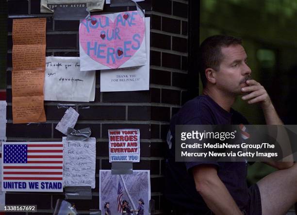 New York City Fire Department firefighter Charley Maloney sits pensively next to notes given to New York Fire Department's Squad 18 on September 18,...