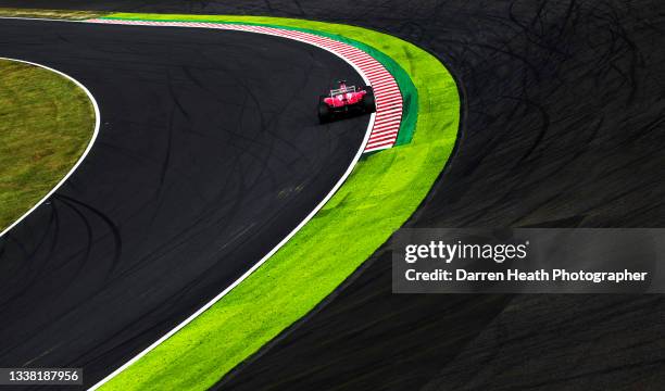 Brazilian Scuderia Ferrari Formula One team racing driver Felipe Massa driving his F2012 racing car at speed around the famous Turn 15 known as 130R...