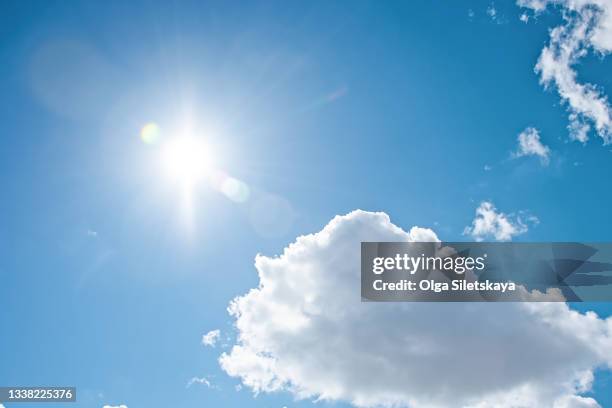 clear blue sky background with clouds and bright sun - sol fotografías e imágenes de stock