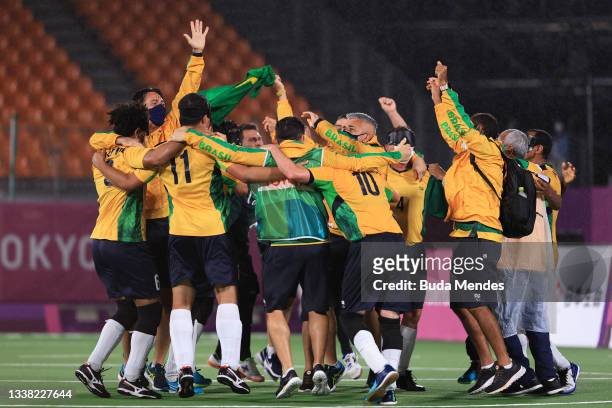 Player and coaching staff members of Brazil celebrate their victory over Argentina by 1-0 in football 5-a-side gold Medal Match on day 11 of the...