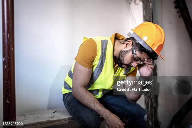 exhausted construction worker at construction site - laborer stock pictures, royalty-free photos & images